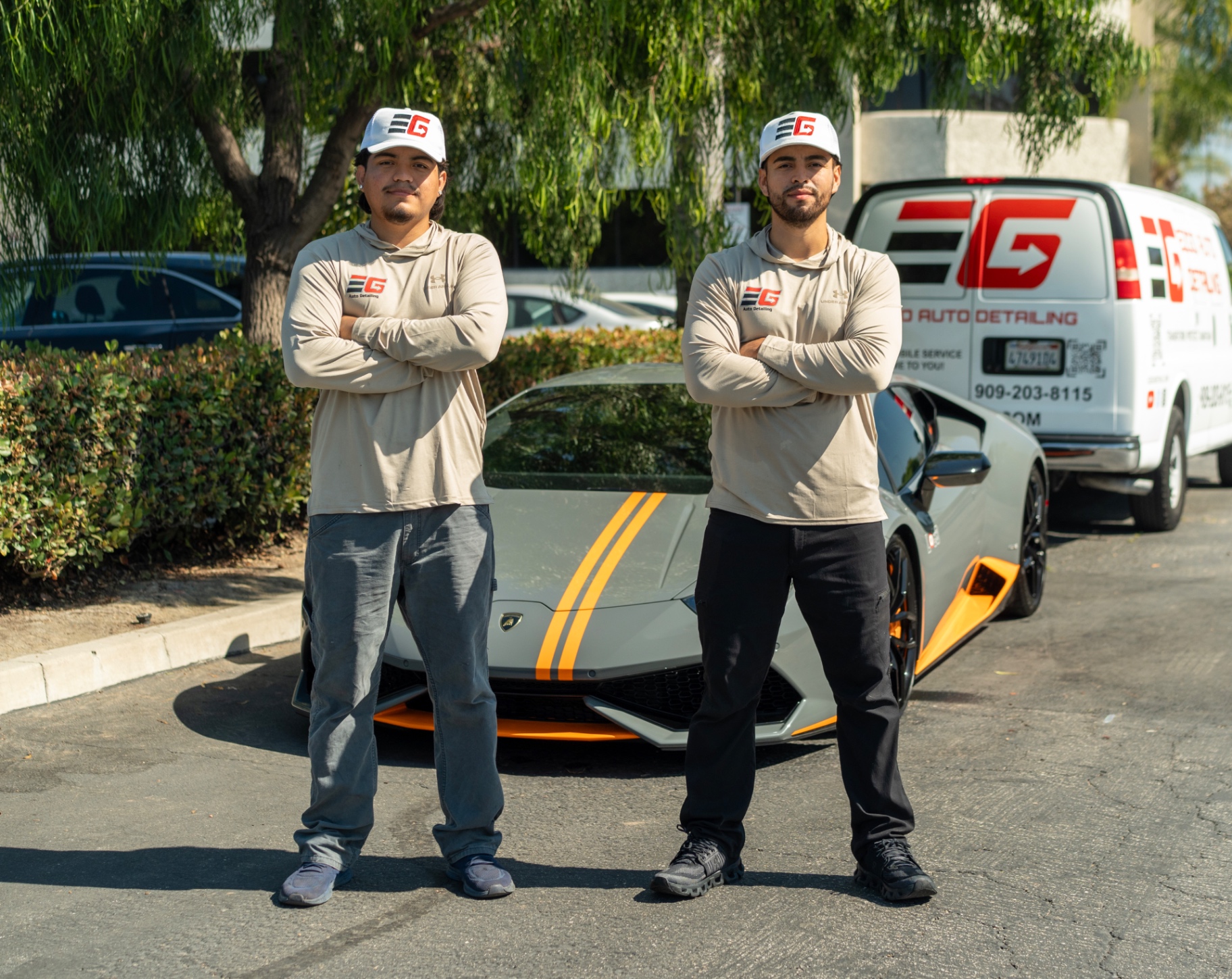 The EZGO Auto Detailing team standing with a Lamborghini and the EZGO mobile van